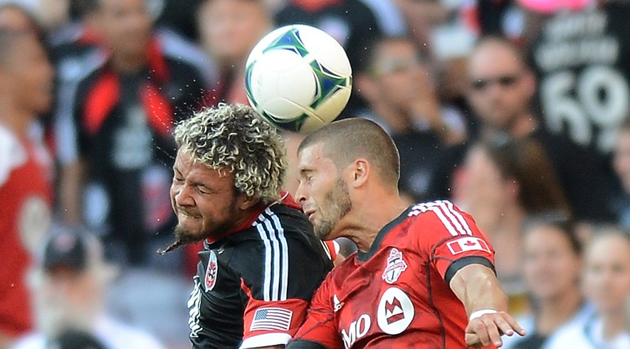 D.C. United midfielder Nick DeLeon (left) and Toronto FC defender Ryan Richter battle for a head ball in the first half at RFK Stadium in Washington, D.C., Saturday, June 15, 2013.