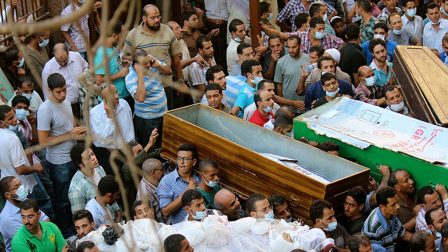 Residents try to move their dead into the overwhelmed Zeinhoum mosque in Cairo in an effort to get them outside of the heat, Thursday, Aug. 15, 2013, a day after the military's crackdown on sit-in sites.