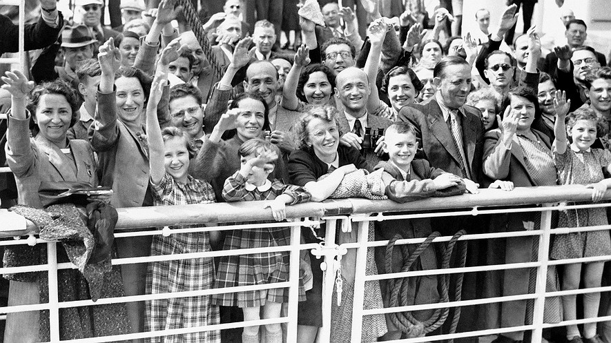 In this June 17, 1939, photo, German Jewish refugees sail to Antwerp, Belgium, aboard the St. Louis after they had been denied entrance to the United States. Photo: AP/File. BOTTOM: Sol Messinger holds a book written about his voyage on the St. Louis at his home in Buffalo, New York, Nov. 20, 2015.
