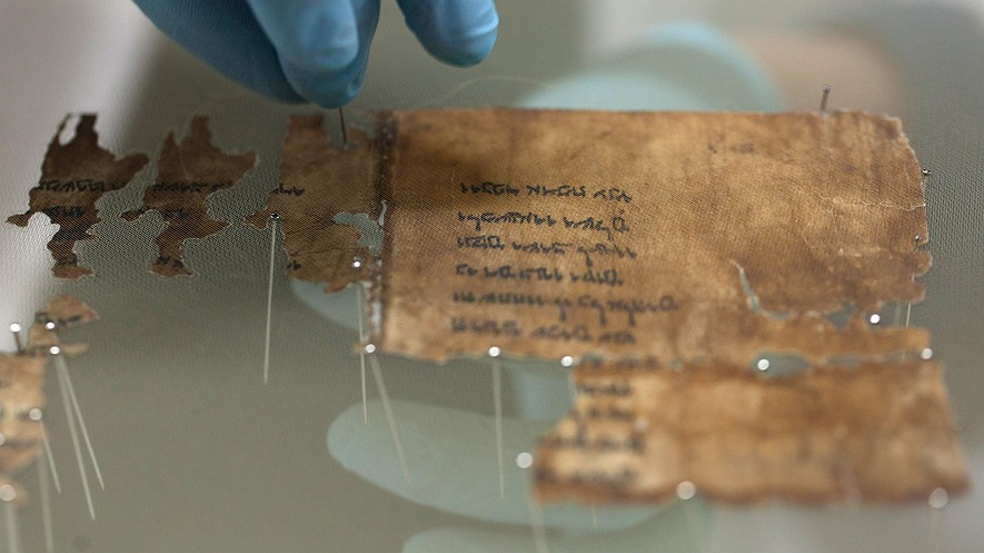 A conservation analyst with the Israel Antiquities Authority prepares fragments of the 2,000-year-old Dead Sea Scrolls at a laboratory before photographing them on December 18, 2012, in Jerusalem, Israel. Photo by: Uriel Sinai/Getty Images