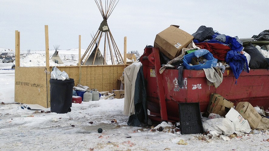 Trash is piled in a dumpster at an encampment set up near Cannon Ball, North Dakota, February 8, 2017, for opponents against the construction of the Dakota Access pipeline. Photo by: AP Photo/James MacPherson