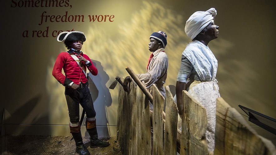This April 13, 2017, photo depicts 14-year-old London Pleasants (left) who left slavery by joining a Loyalist regiment encouraging other slaves to flee to the British Army in search of freedom, at the Museum of the American Revolution in Philadelphia, Pennsylvania. AP Photo/Matt Rourke